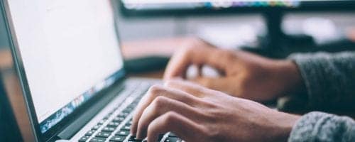 person typing on a computer